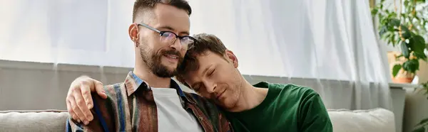 Two men, a gay creative couple, sit closely discussing trendy attire in a designer workshop. — Stock Photo