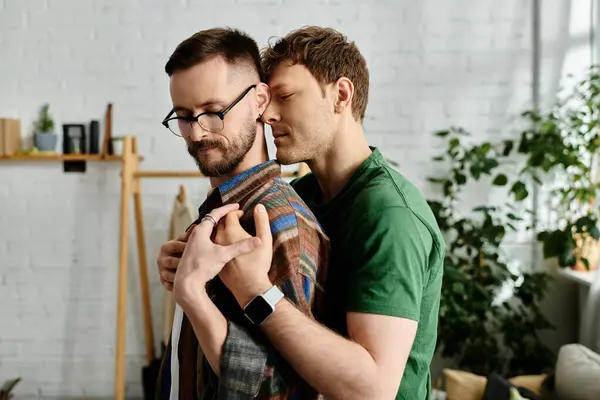 Two men, a gay couple, stand side by side in a designer workshop, creating trendy attire for a fashion show. — Stock Photo