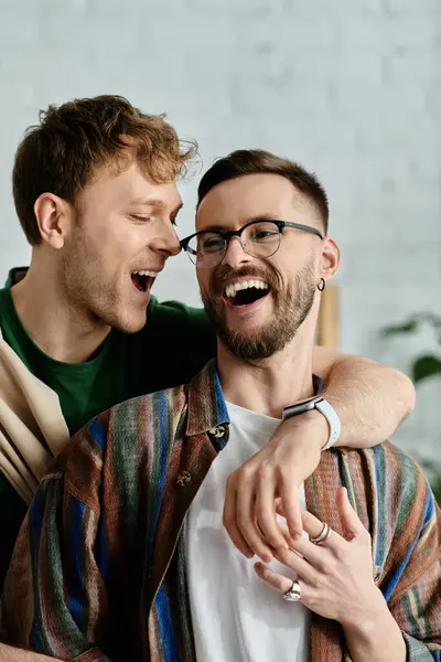 A man and woman joyfully laugh together in a designer workshop. — Stock Photo