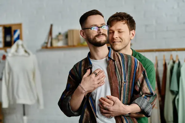 Two men hugging while standing together in atelier — Stock Photo