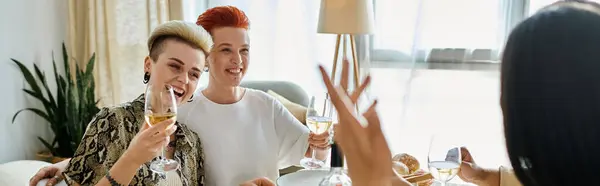 Diverse group enjoys wine together at dinner table. — Stock Photo