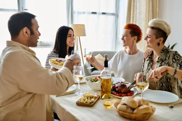 Diverse group enjoying a meal together at a table. — Stock Photo