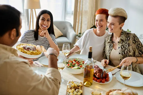 Diverse friends enjoy a meal together at a table. — Stock Photo