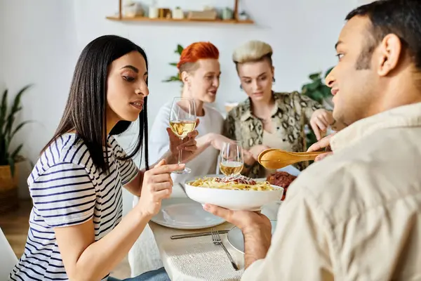 Diverse friends enjoying a meal together with wine. — Stock Photo
