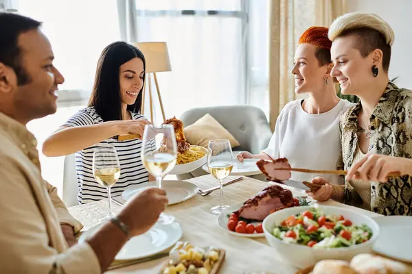 Diverse group enjoying a meal together at a table. — Stock Photo