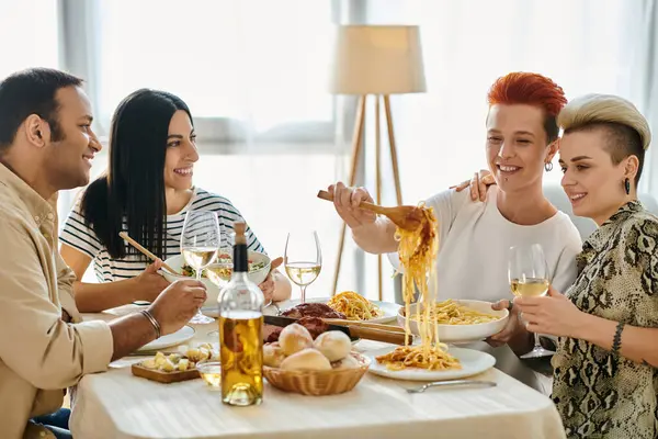 A diverse group of friends, including a loving lesbian couple, enjoying a meal together at a table. — Stock Photo