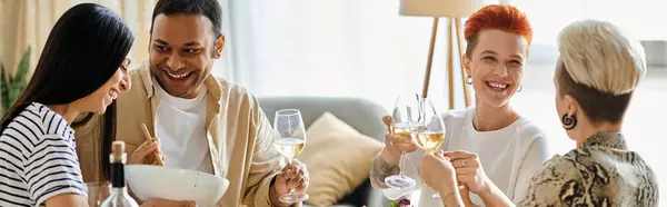 Diverse group sits around table, enjoying wine and good company. — Stock Photo