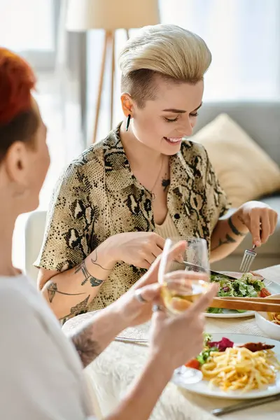 Woman enjoying a meal with diverse friends at a table. — Stock Photo