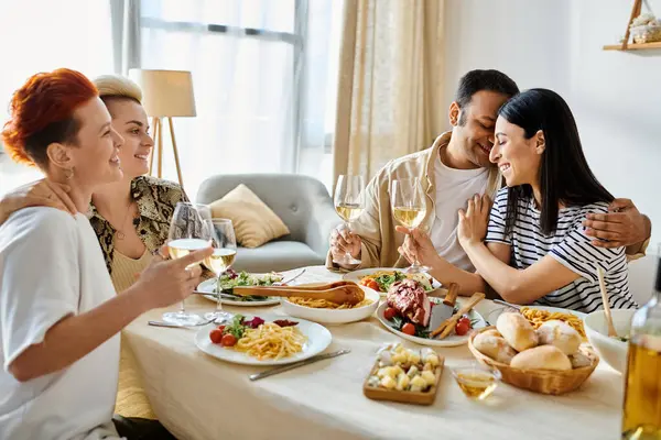 Diverse group enjoys food and wine together at cozy dinner party. — Stock Photo