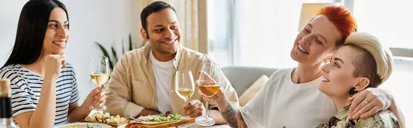 Diverse group of friends enjoy a meal hosted by a loving lesbian couple at home. — Stock Photo