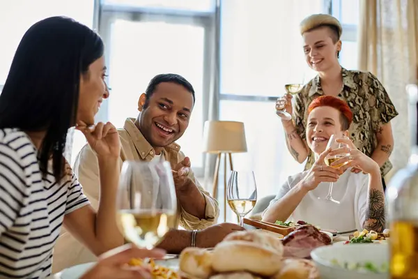 Diverse group enjoying wine around a table. — Stock Photo
