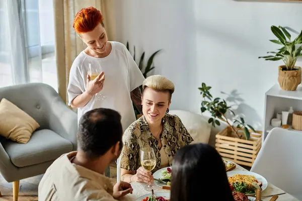 Diverse group enjoying dinner together at a table. — Stock Photo