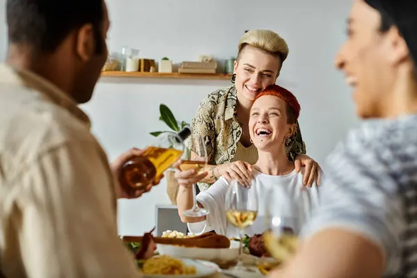 Diverse group sharing a meal at home. — Stock Photo