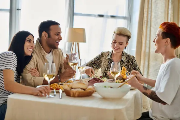 A group of people enjoying food and wine together at a table. — Stock Photo