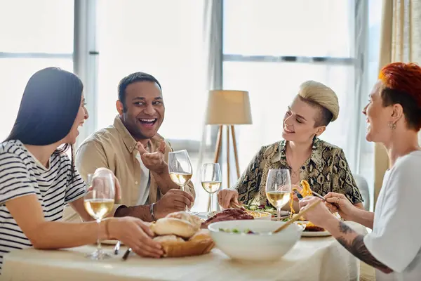 Diverse group enjoying dinner with wine at table. — Stock Photo