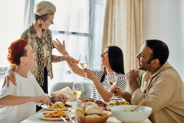 A group of people sitting around a table, enjoying a meal together. — Stock Photo