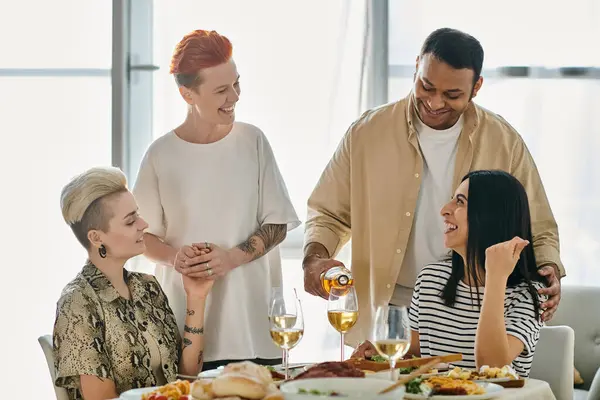 Diverse group enjoying meal together at table. — Stock Photo