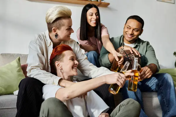 A diverse group of people, including a loving lesbian couple, sharing moments on a couch. — Stock Photo