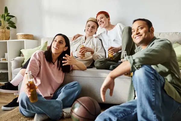 Diverse group of friends, including a loving lesbian couple, sitting on top of a couch, enjoying quality time together at home. — Stock Photo