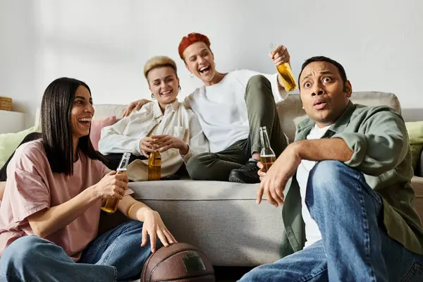 Group of friends, including a loving lesbian couple, relaxing on top of a couch at home. — Stock Photo