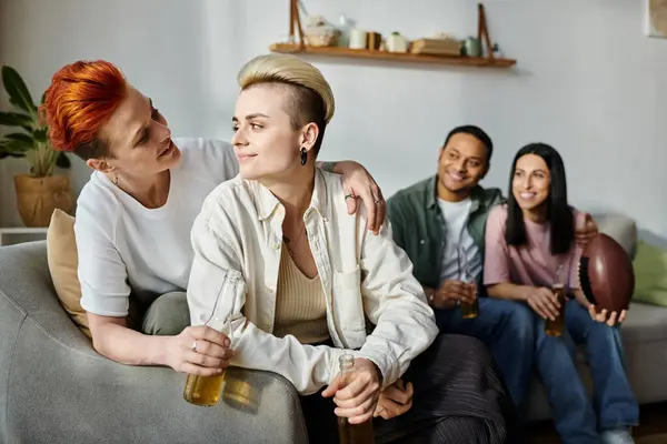 Diverse group of friends, including a loving lesbian couple, enjoy relaxing together on top of a couch. — Stock Photo