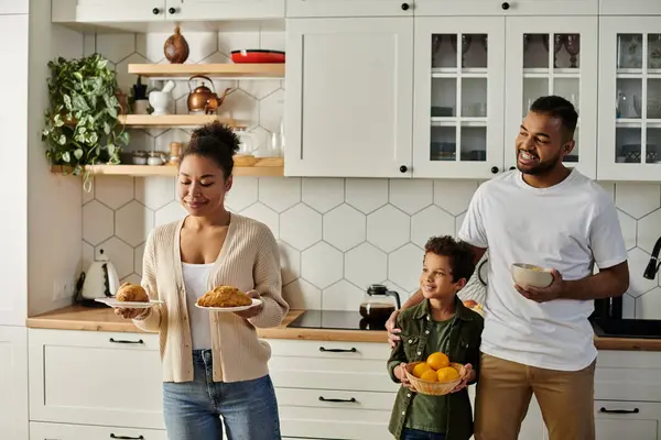 Loving African American family prepares food in kitchen together. — Stock Photo