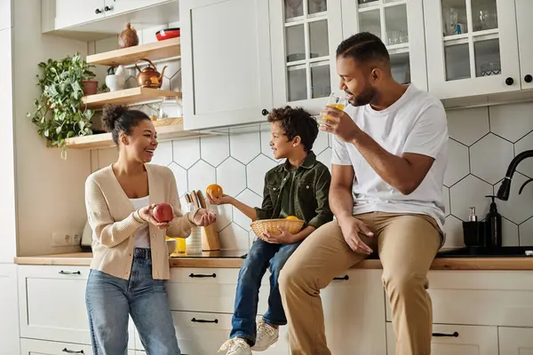 African American family enjoying a meal on kitchen counter together. — Stock Photo