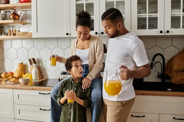 Loving African American family, sit together in a cozy kitchen. — Stock Photo