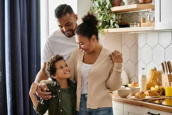 A man and woman with a child in a kitchen. — Stock Photo