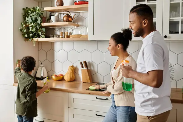 A man and a woman cleaning together in a vibrant kitchen. — Stock Photo