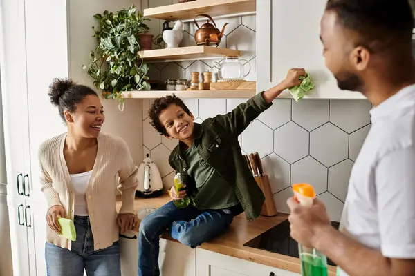 African american family engage in conversation and bonding around a kitchen counter. — Stock Photo
