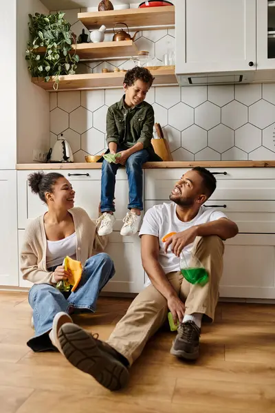 African american family bonding on floor in cozy kitchen. — Stock Photo