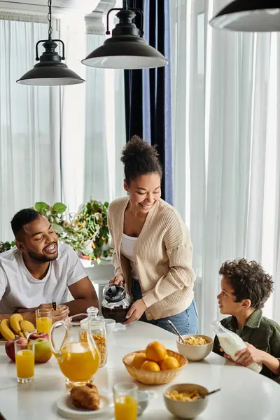 African american family having breakfast around white table. — Stock Photo