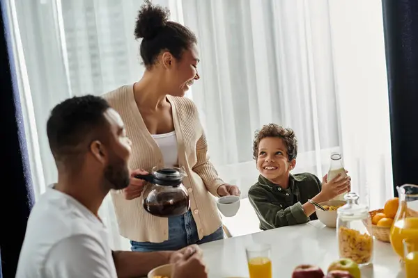 A loving African American family enjoying a meal together at a table. — Stock Photo