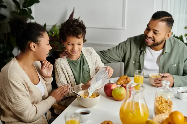 African american family enjoys a meal together at a table, fostering love and connection. — Stock Photo