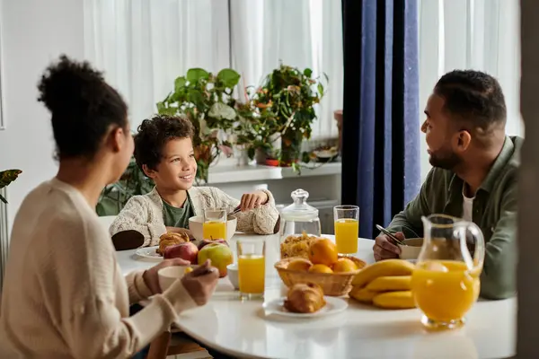 African american family enjoying a meal together at a table. — Stock Photo
