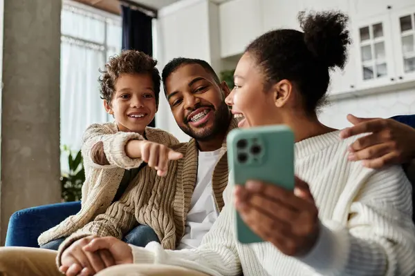 African American family joyfully taking selfie together with cell phone. — Stock Photo