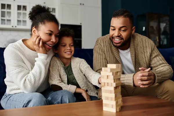 A man and woman engaging in a fun game with a child. — Stock Photo