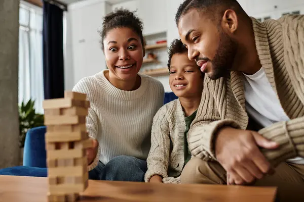 African american family building together with wooden blocks. — Stock Photo