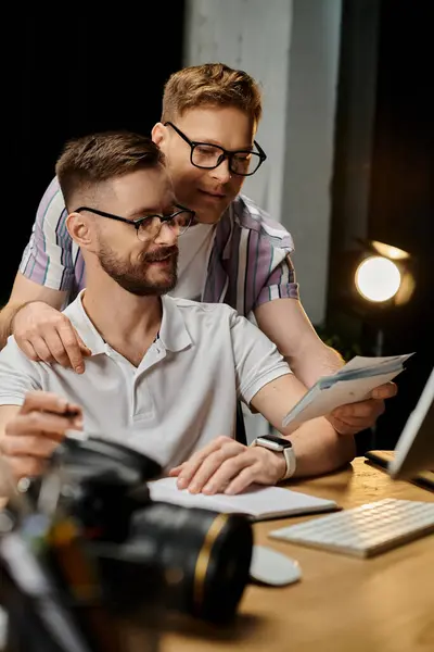 Two loving men engaging with computer screen in office setting. — Stock Photo