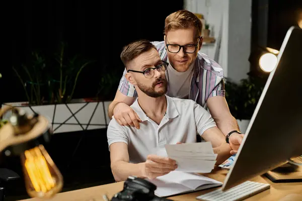 Two loving men focus on computer screen in office. — Stock Photo