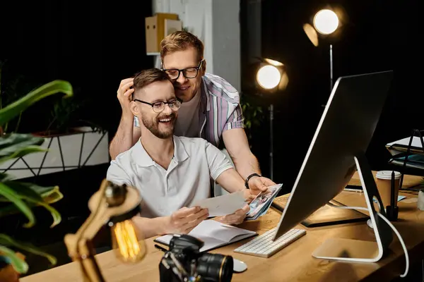 Two loving men engrossed in a laptop screen. — Stock Photo