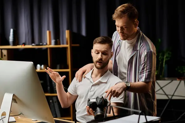 Men in office attire engage with computer screen. — Stock Photo