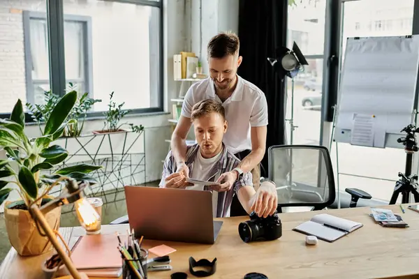 Two loving men engrossed in laptop screen. — Stock Photo