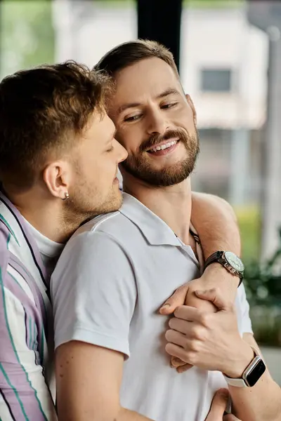 Two men joyfully embrace in a room. — Stock Photo