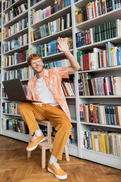 A man sitting in front of a laptop and immersing himself in studying. — Stock Photo