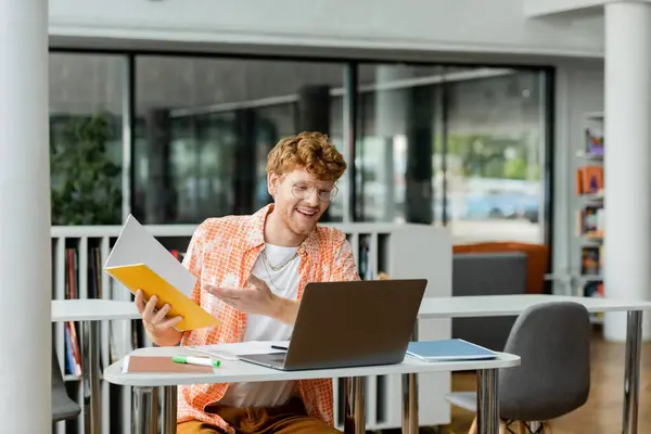 Young man with laptop, focused and studying in library. — Stock Photo