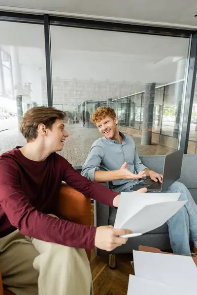 Two young men studying together in a library. — Stock Photo