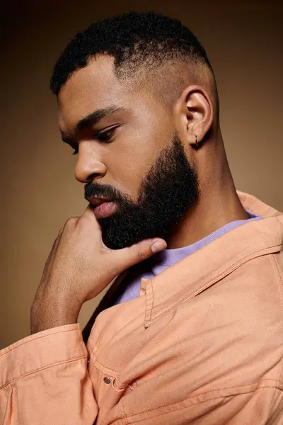 Close-up of a stylish African American man with a full beard, striking a pose against a colorful background. — Stock Photo