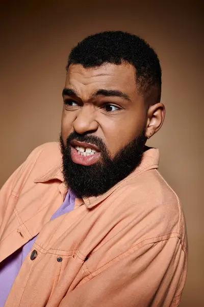 Handsome man with beard in trendy shirt striking a pose. — Stock Photo
